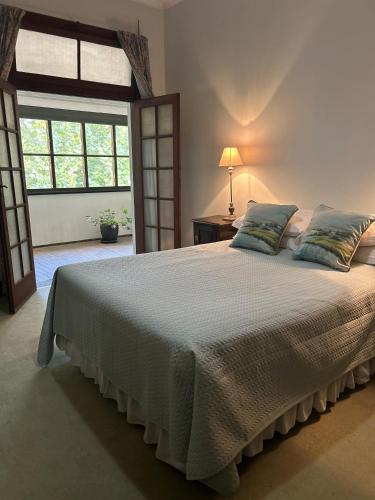 a bedroom with a large bed and a window at The Riverine Club in Wagga Wagga