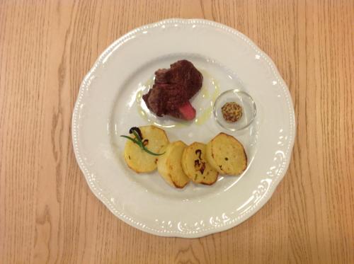 a white plate with food on a wooden table at Domus Australia in Rome