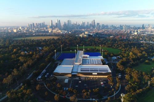 an aerial view of a building with a city in the background at A 2BR Apt in Parkville Near the Melbourne Zoo in Melbourne