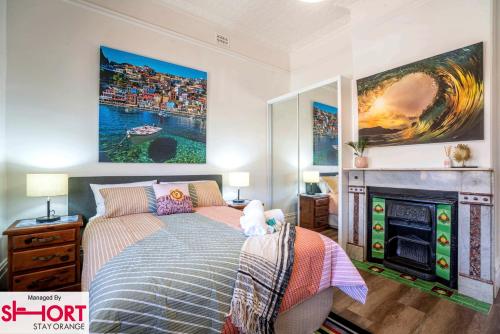 a bedroom with a bed and a fire place at Paddington Villa 1 - Free Wi-fi, Netflix in Orange