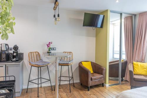 a living room with a table and two chairs at Studio 86 - Climatisation & proche centre-ville- 2 personnes - BnB Epernay in Épernay