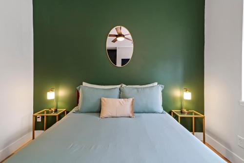 a bedroom with a large bed and a mirror at Spacious 8BR-4BA Group HQ Patio&Games Soulard in Soulard