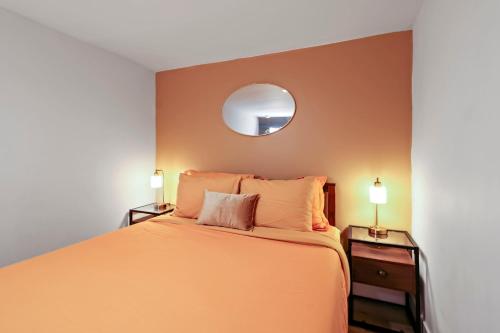a bedroom with a large bed and a mirror at Spacious 8BR-4BA Group HQ Patio&Games Soulard in Soulard