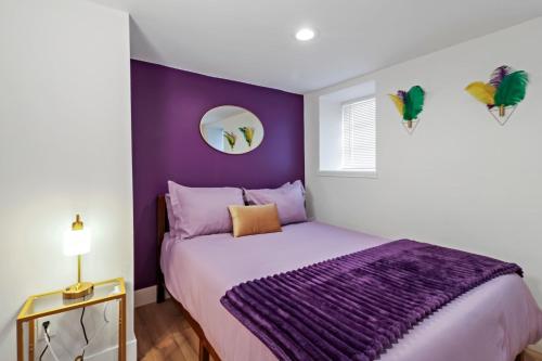 a purple bedroom with a bed with a purple blanket at Spacious 8BR-4BA Group HQ Patio&Games Soulard in Soulard