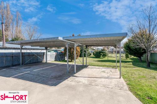 a parking lot with a roof on top of it at Paddington Villa 2 - wi-fi, Netflix in Orange
