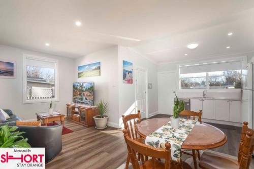 a dining room and living room with a table and chairs at Paddington Villa 2 - wi-fi, Netflix in Orange