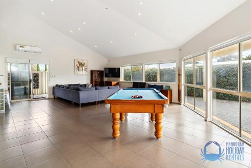 a living room with a pool table in it at Relax at Falcon By The Bay in Mandurah