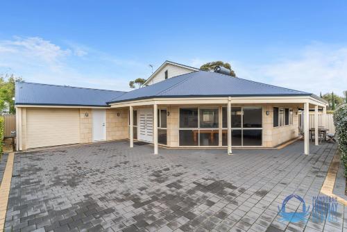 a house with a large driveway in front of it at Relax at Falcon By The Bay in Mandurah