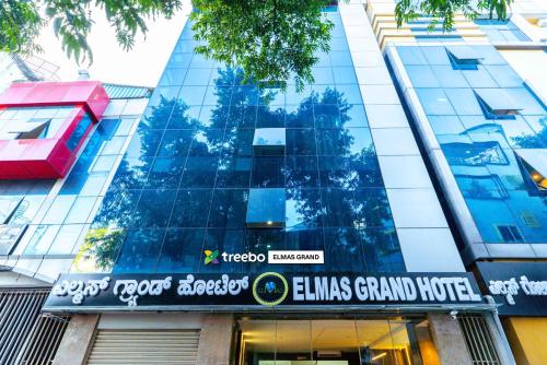a building with a sign on the front of it at Treebo Elmas Grand in Bengaluru