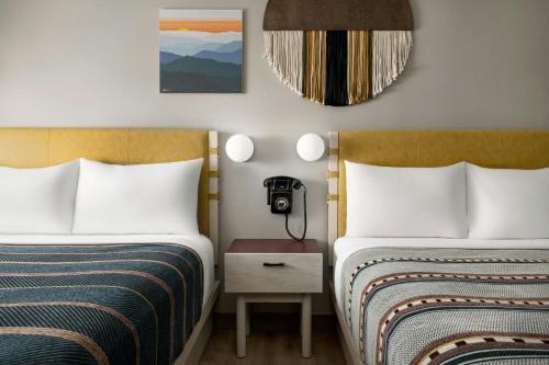 a hotel room with two beds and a phone at Moxy Asheville in Asheville