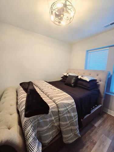 a bedroom with a bed with a blanket on it at Cozy & Near Downtown & Hyde Park in Chicago