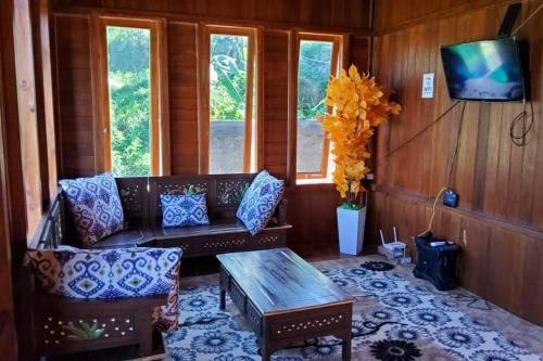 a living room with a couch and a coffee table at Villa Zoya 1 in Bogor