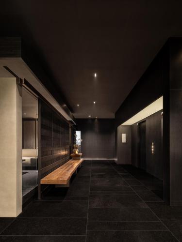 a hallway with a wooden bench in a building at SAVHE Atour Hotel on the Bund Nanjing Road Pedestrian Street -Free night snacks and afternoon tea in Shanghai