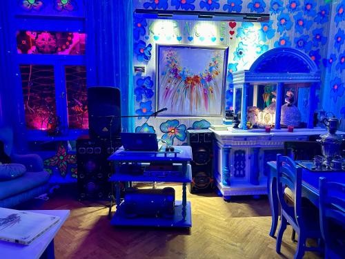 a room with blue lighting and a table with a laptop at Napoli Nataxtari hotel,pool,bar,kamping in Natakhtari