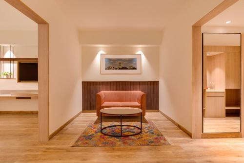a chair and a table in a hallway at Red Fox by Lemon Tree Hotels, Hyderabad in Hyderabad