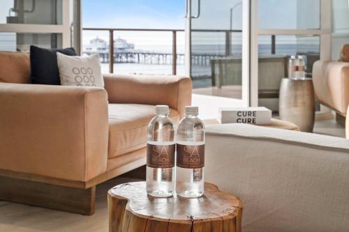 two bottles of water on a table in a living room at SA Carbon Beach Suites in Malibu