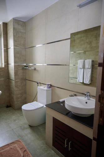a bathroom with a toilet and a sink at Kethumathee Hotel & Banquet in Ratnapura