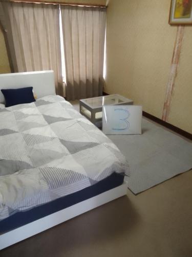 a bedroom with a bed with the number on it at Yoshinogawa - House - Vacation STAY 98528v in Yoshinogawa
