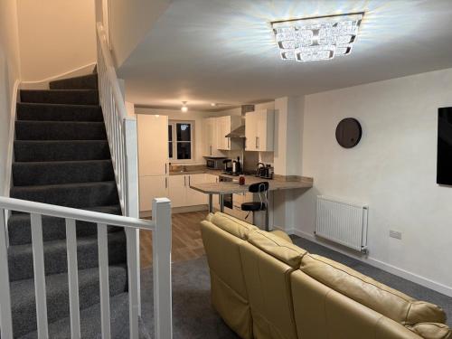 a living room with a couch and a kitchen at Jakes Beach house in Hartlepool