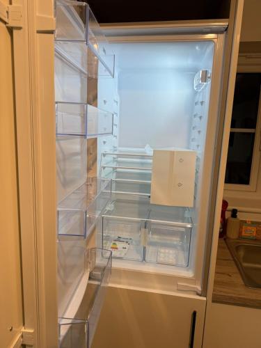 a refrigerator with its door open with a box in it at Jakes Beach house in Hartlepool