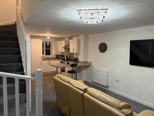 a living room with a couch and a kitchen at Jakes Beach house in Hartlepool