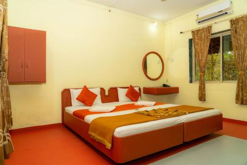 a bedroom with a large bed in a room at Wild Camp- The Nature Resort in Khodāla