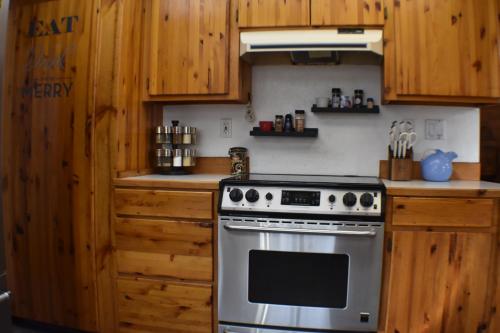 a kitchen with a stove and wooden cabinets at Wild Orchards Camas in Camas