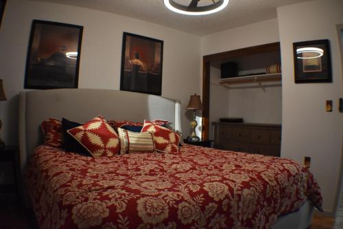 a bedroom with a bed with a red comforter at Wild Orchards Camas in Camas