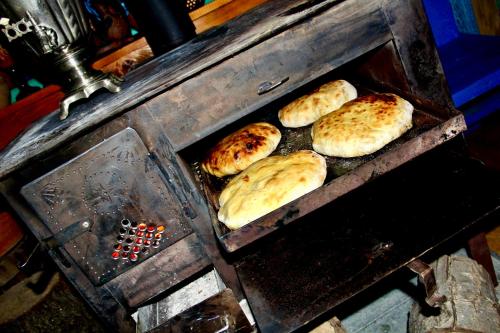 four buns are being cooked in an oven at Napoli Nataxtari hotel,pool,bar,kamping in Natakhtari