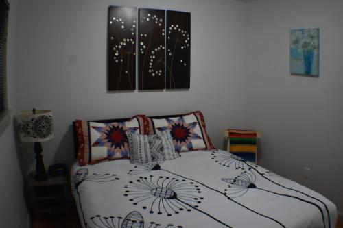 a bed in a bedroom with two pictures on the wall at Wild Orchards Camas in Camas