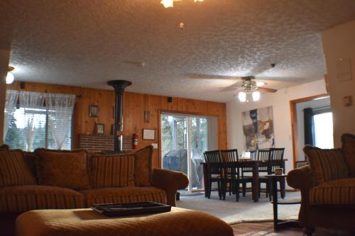 a living room with couches and a dining room with a table at Wild Orchards Camas in Camas