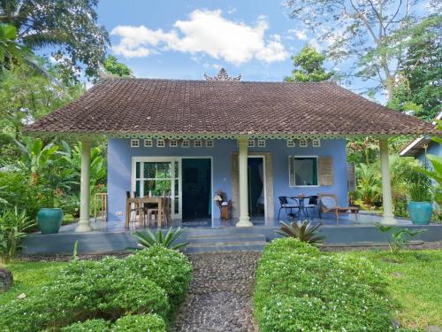a small blue house with a roof at Darmada Eco Resort in Sidemen