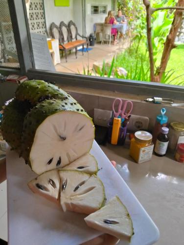 a plate of food with a cut up pineapple on it at Condro Wulan Hostel in Malang