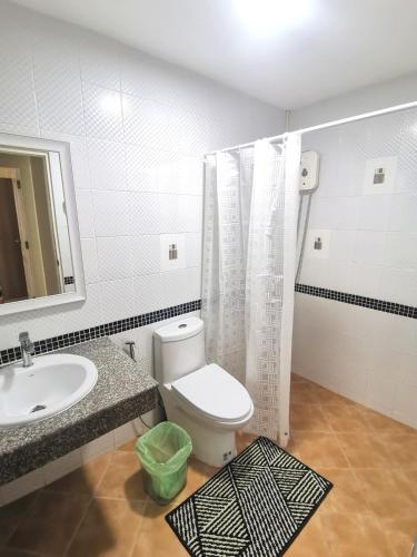 a bathroom with a toilet and a sink and a mirror at Kata beach Townhouse BL2 in Kata Beach