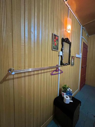 a room with a wall with a mirror and a table at Perhentian Sri Tanjung , Kampung Nelayan Pulau Perhentian in Perhentian Island