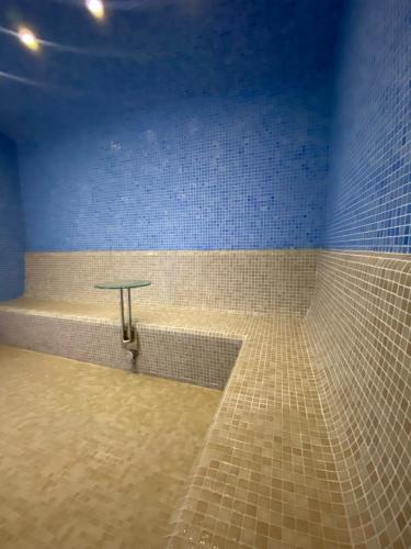 a bathroom with a tub with a table in it at The Bentley Luxury Hotel & Suites in Doha