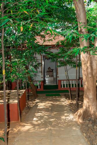 a building with trees in front of it at Wild Camp- The Nature Resort in Khodāla