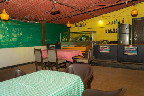 a dining room with a table and chairs in a restaurant at Wild Camp- The Nature Resort in Khodāla