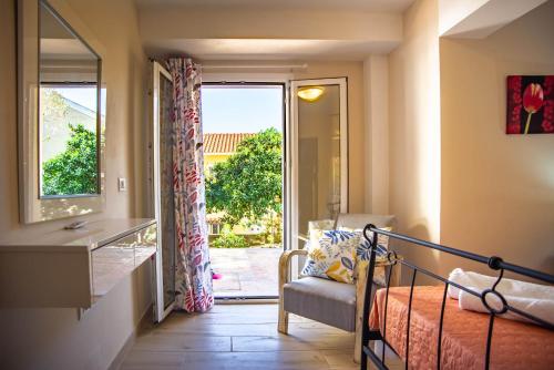 a bedroom with a bed and a sliding glass door at Casa Giardino in Argostoli