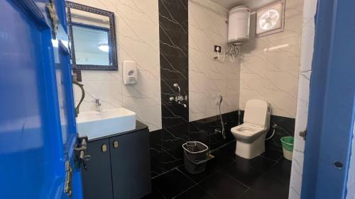 a bathroom with a white toilet and a sink at Storica Stays in Jodhpur