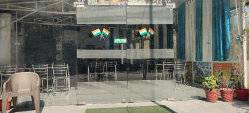a window of a store with a bunch of chairs at KC Hotel & Restaurant in Rudraprayāg