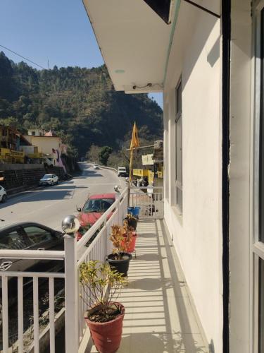 a balcony with potted plants on the side of a building at KC Hotel & Restaurant in Rudraprayāg