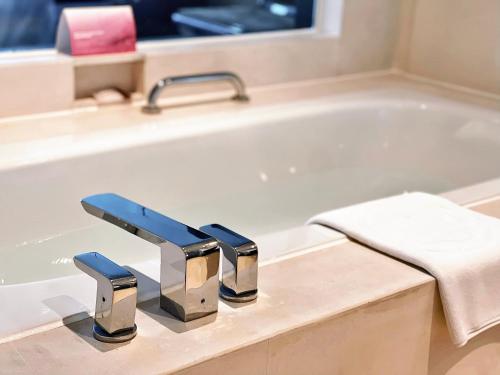 a bathroom sink with a bath tub at Swiss Grand Xiamen-Harbour View in Xiamen