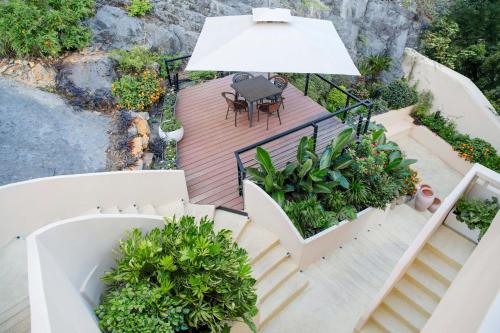 an overhead view of a patio with a table and an umbrella at Xiangui Jingshan Villa in Guilin