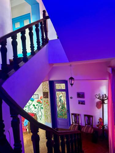 a hallway with a staircase with a purple ceiling at Napoli Nataxtari hotel,pool,bar,kamping in Natakhtari