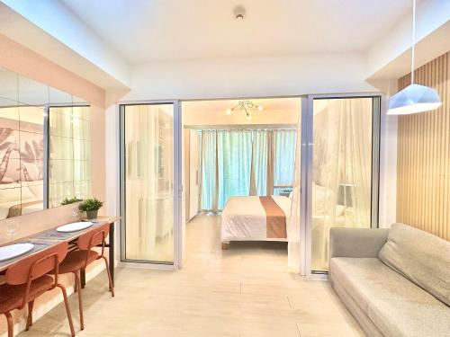 a living room with a bed and a couch at Azure Urban Resort South Paranaque Beach View Unit- Newly Renovated - Near Airport Near SM Bicutan in Manila