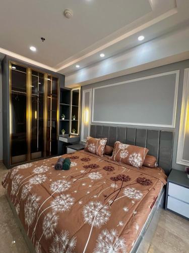 a bedroom with a large bed with a large window at Apartment Medan Podomoro City Deli by OLS Studio in Medan