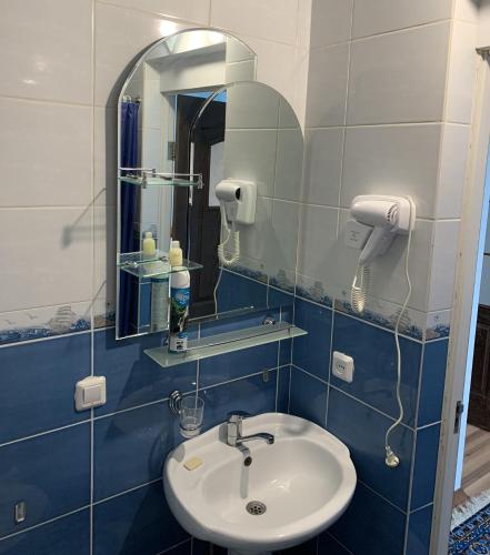 a bathroom with a sink and a mirror at Гостевой дом "Светлана" in Cholpon-Ata