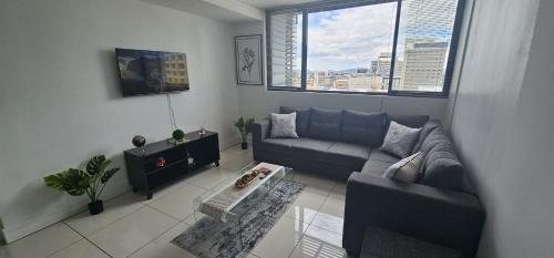 a living room with a couch and a table at 247 Luxury Stays in Windhoek