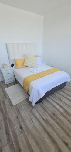 a bedroom with a bed and a wooden floor at 247 Luxury Stays in Windhoek